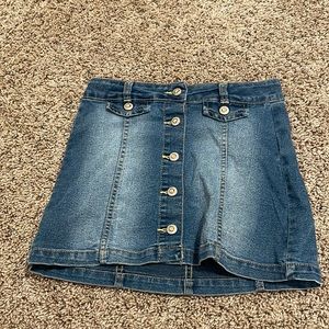 This is a Jean skirt with fake orange/pink gems in the middle of each button!
